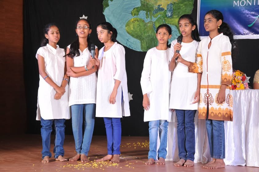 Students speaking on stage during a school event