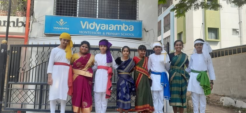 Vidyaramba Montessori campus entrance with students in traditional attire