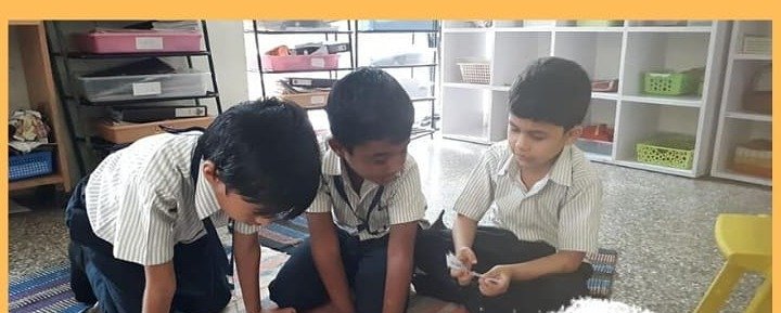 Students exploring Montessori practical-life materials in the classroom
