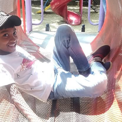 Group of Vidyaramba students smiling on outdoor play equipment